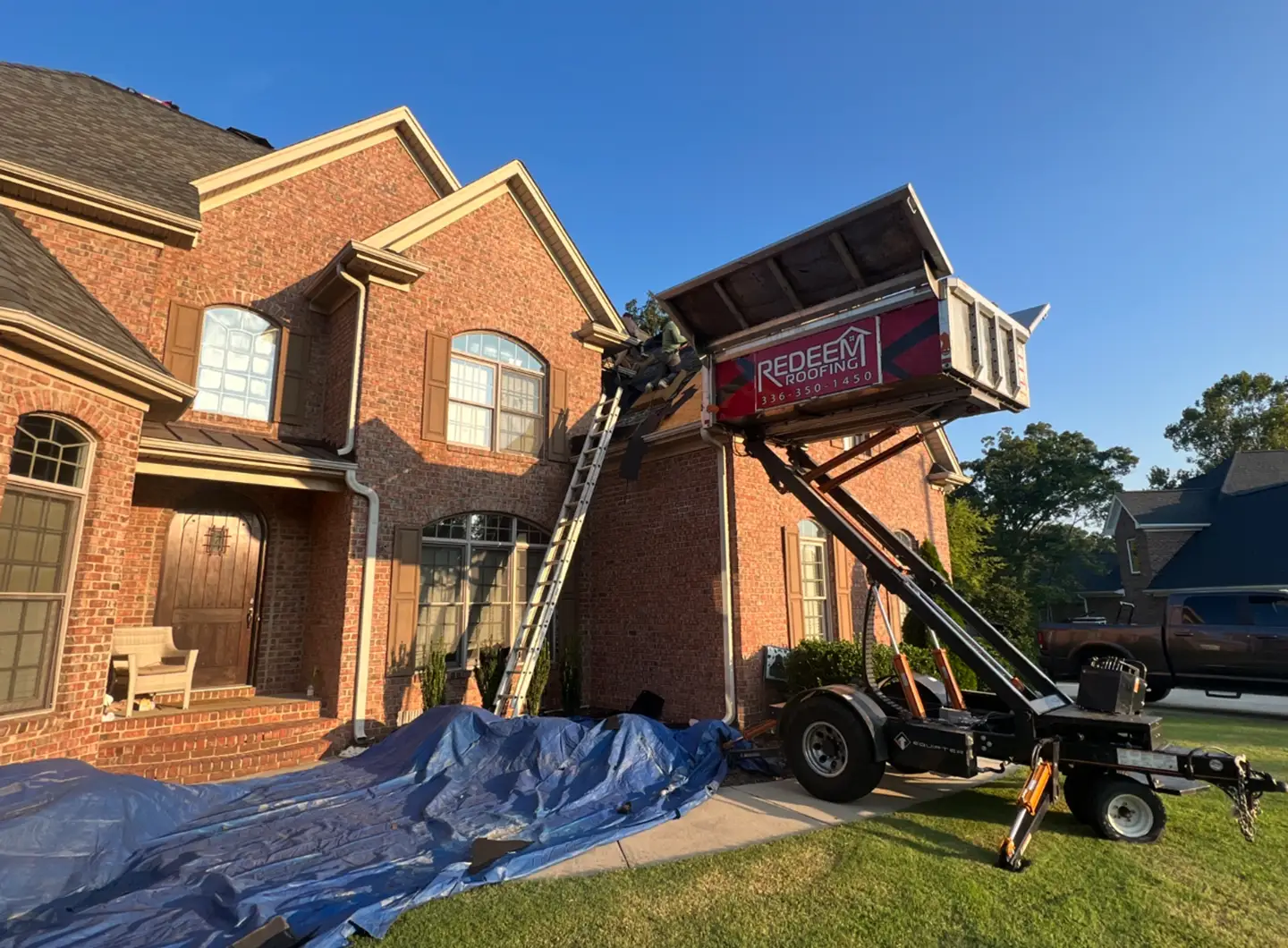 Redeem Roofing & Construction crew working on a roof in the Piedmont Triad